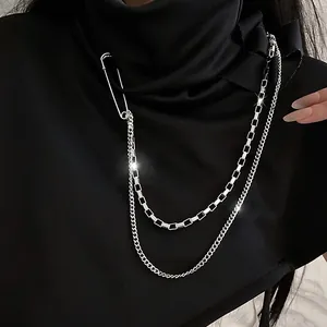 Detailed macro shot of a silver long chain brooch in a hip-hop street style design.