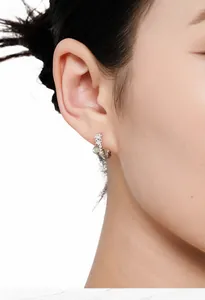 Elegant S925 sterling silver flower ear cuff with green stone detail shown on Asian model