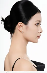 Side profile view of a model wearing small S925 sterling silver flower hoop earrings.