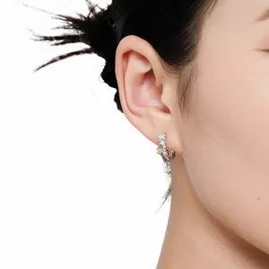 Elegant S925 sterling silver flower hoop earrings with irregular texture on Asian model