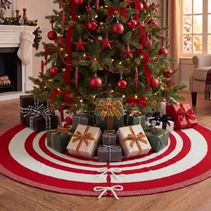 Close-up of a 48-inch red and white knitted Christmas tree skirt with bow ties.