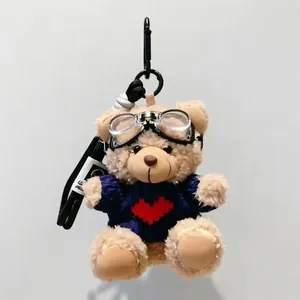 Plush pilot teddy bear keychain wearing navy sweater with red heart