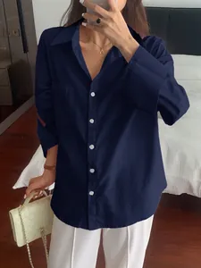 Detailed view of a navy blue long-sleeve casual button-up shirt in a mirror selfie