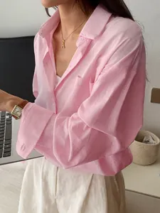 Detailed view of women's pink long-sleeved leisure shirt with textured fabric detail