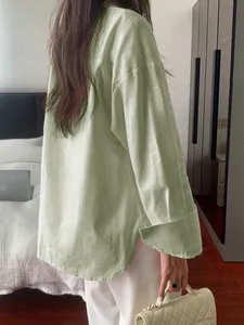 Back detail of women's light green leisure shirt showing fabric texture and loose fit