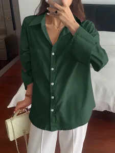 Detailed view of casual dark green long-sleeved button-down shirt with front pocket