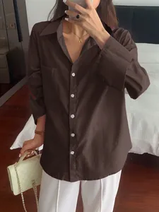 Detailed view of women's coffee brown long-sleeved casual shirt with white buttons