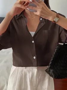 Detail view of dark brown linen texture button-down blouse for women's leisure style