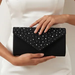 Detailed view of elegant black pleated evening clutch with sparkling rhinestones