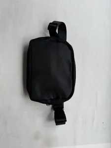 Detailed view of a minimalist black nylon belt bag for outdoor sports and running