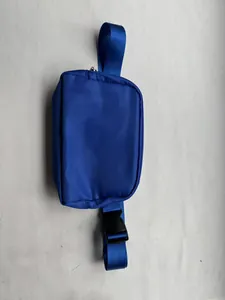 Close-up detail of a blue nylon adjustable running belt bag with a sturdy black buckle
