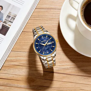 Macro view of luxury two-tone men's stainless steel watch featuring a deep blue dial.