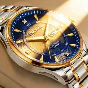 Close-up view of gold and silver men's watch featuring a blue dial and double calendar.
