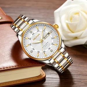 Close-up of men's two-tone steel watch with white dial and dual calendar display