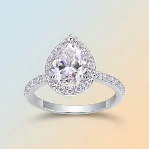 Elegant pear-shaped moissanite S925 silver halo ring with pavé band on gradient background