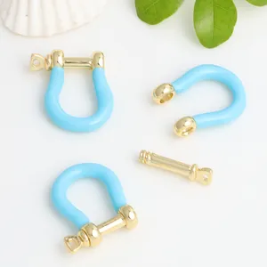 Detail view of blue enamel gold-plated copper U-shape horseshoe buckle for DIY jewelry