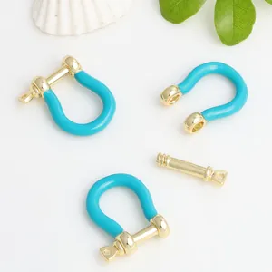 Detail view of turquoise enamel U-shaped copper shackle clasps for jewelry DIY projects