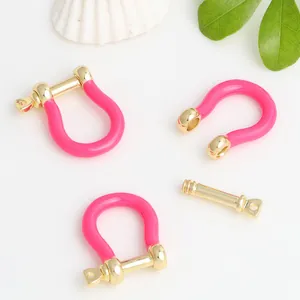 Detail of pink enamel U-shaped horseshoe buckles and screw pins for jewelry DIY
