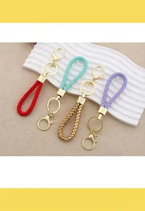 Detail view of colorful braided leather rope keychains with gold lobster clasps