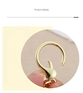 Detailed close-up view of a golden round metal carabiner clasp for handmade keychains