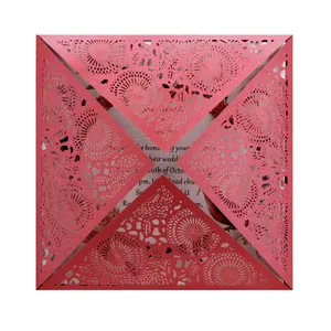Elegant red laser-cut wedding invitation card with intricate floral hollow-out pattern.