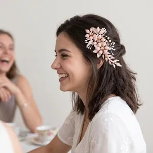 Detailed view of a rose gold handmade flower hair clip with alloy leaves on a model's hair.