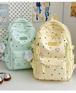 Paire de sacs à dos pastel menthe et jaune à pois avec motifs oursons et breloques douces