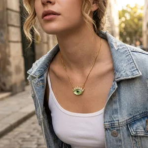 Detailed view of gold-plated evil eye necklace with green sun pendant on model