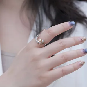 Detail view of S925 silver ring featuring a cute gold bear on a sparkling crescent moon