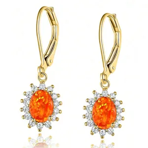 Elegant gold-tone halo drop earrings with oval orange opal and cubic zirconia crystals