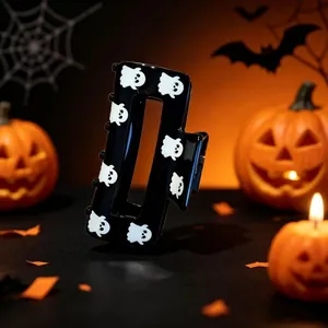 Close-up of a dark style Halloween black hair claw clip featuring cute white ghost prints