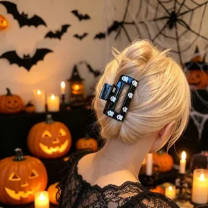 Black Halloween hair claw clip with ghost prints shown in a festive party scene