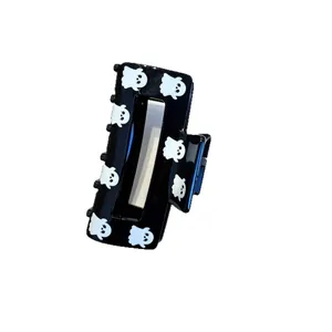 Detailed view of a black Halloween hair claw clip featuring cute white ghost prints for party