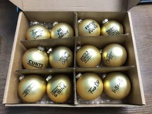 Set of 12 gold Christmas baubles with funny and profane adult slogans in a box