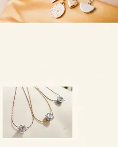 Macro view of minimalist zircon necklaces in gold, rose gold and silver titanium steel