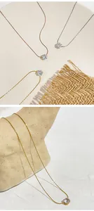 Elegant cubic zirconia necklaces in gold, silver, and rose gold on textured background.