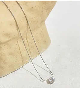 Detailed view of a minimalist titanium steel necklace with a round cubic zirconia pendant