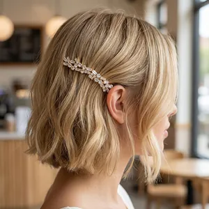 Detailed side view of a gold vintage bridal hair comb with zircon crystals in blonde hair