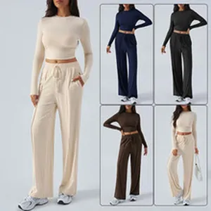 Stylish two-piece ribbed set featuring a long sleeve crop top and matching wide leg trousers
