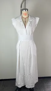 Detailed view of an elegant white summer dress with flutter sleeves on a mannequin