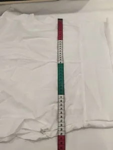 Detail view showing the length measurement of a white stand collar summer dress