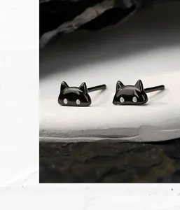 Detailed close-up view of minimalist black cat stud earrings made of S925 sterling silver