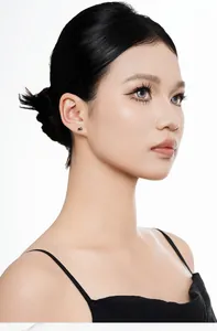 Detailed macro view of S925 sterling silver small black cat stud earring on a female ear