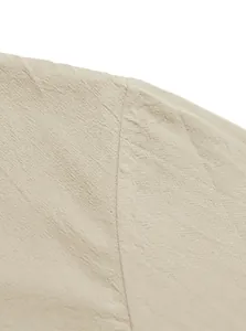 Close-up detail of the durable shoulder seam on this breathable beige linen shirt