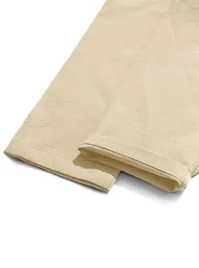Detailed view of breathable beige cotton linen trousers cuff texture