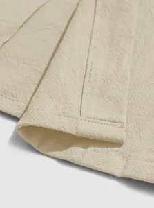 Detail view showing high-quality stitching and breathable linen fabric texture of men's shirt