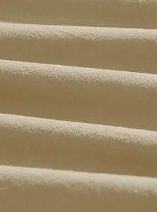 Detailed macro view of beige cotton linen fabric showing natural texture and weave