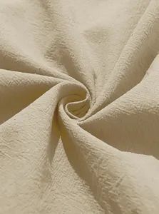 Detailed macro view showing the breathable and soft cotton linen fabric texture in beige