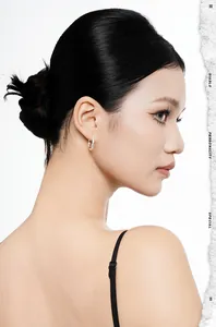 Detailed view of minimalist S925 sterling silver Mobius hoop earrings on model