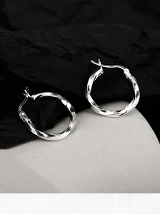 Detail shot of silver Mobius hoop earrings with S925 sterling silver stamp visible
